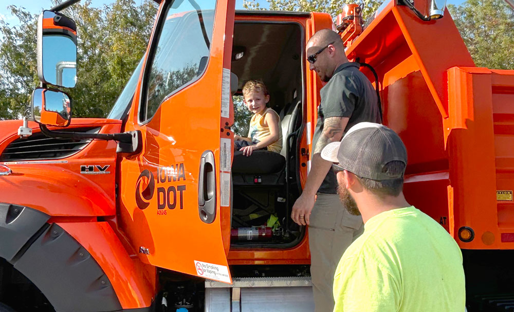 Iowa DOT allowed children to climb into large maintenance trucks at the public appreciation event.